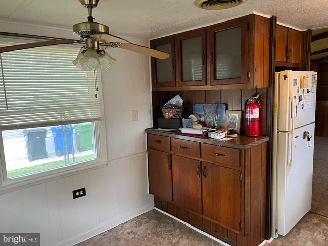 a kitchen with stainless steel appliances granite countertop a refrigerator and cabinets