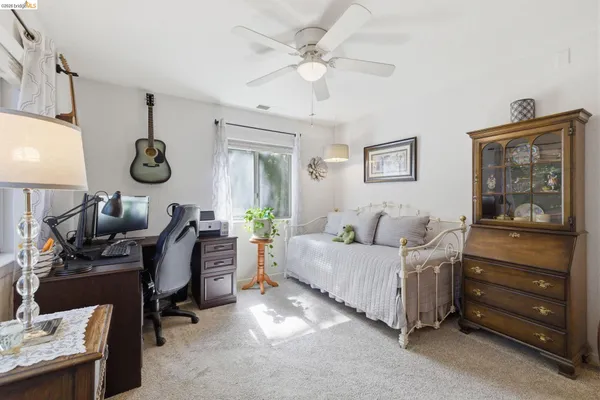 a bedroom with a bed and a desk