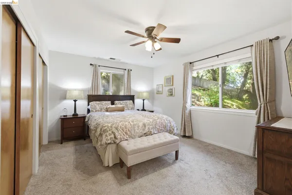 a bedroom with a large bed and a chandelier
