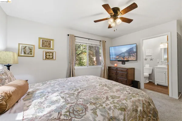 a bedroom with a large bed and a chandelier