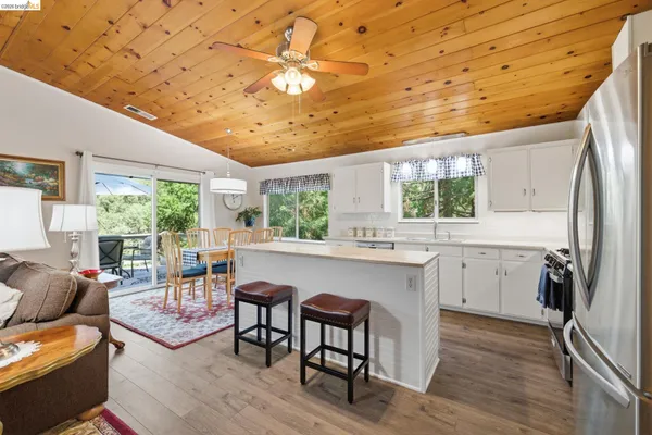 a kitchen with a table chairs refrigerator and cabinets