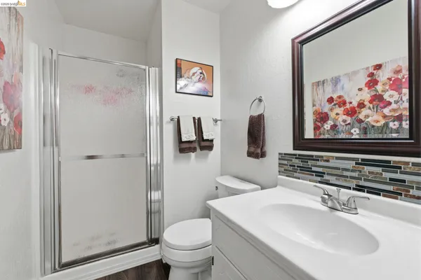 a bathroom with a sink and mirror with toilet