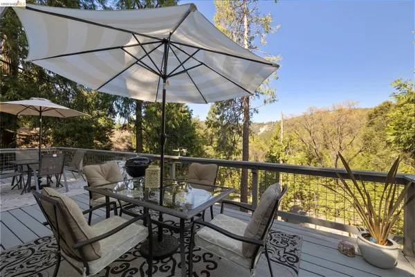 a view of balcony with furniture and umbrella