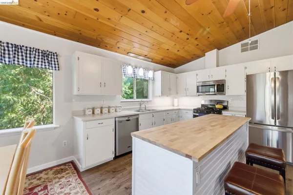a kitchen with a sink a refrigerator and a stove