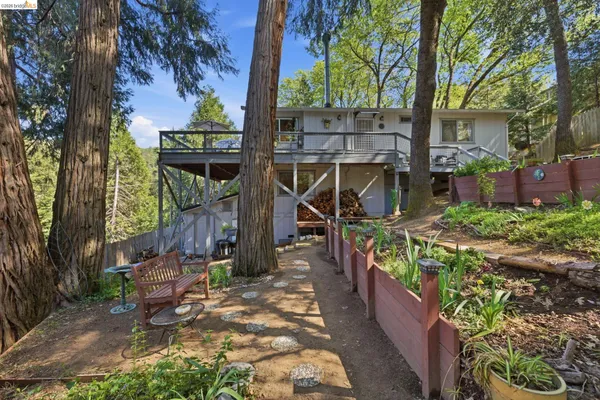front view of a house with a tree in a yard