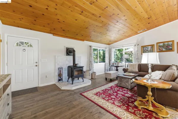 a living room with furniture a rug and a table