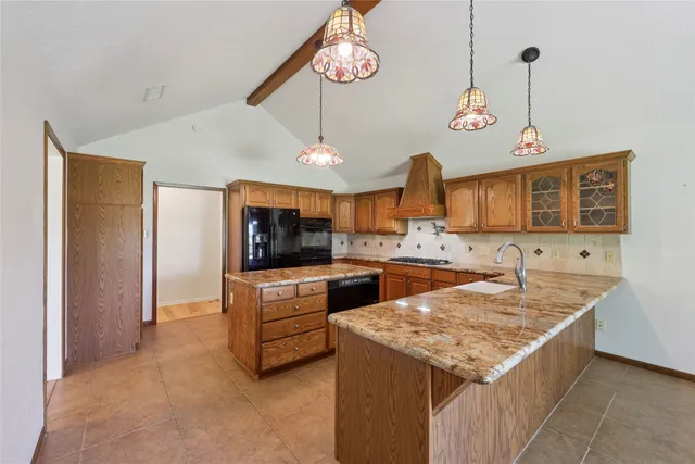 a kitchen with cabinets and chandelier