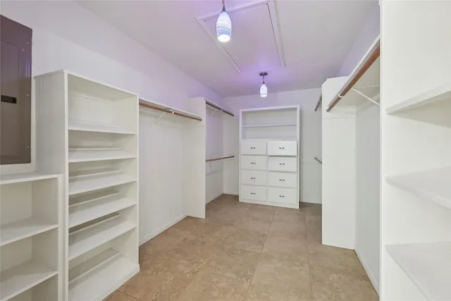 a view of walk in closet with empty racks