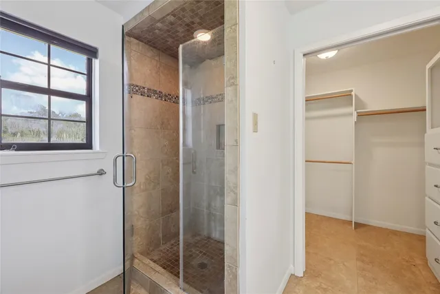 a bathroom with a glass shower door