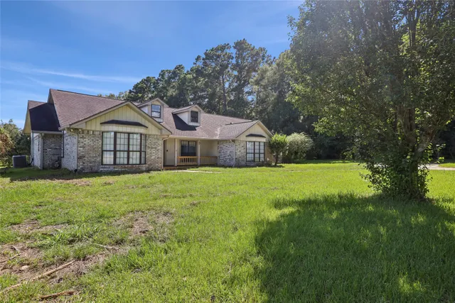 a front view of house with yard and green space
