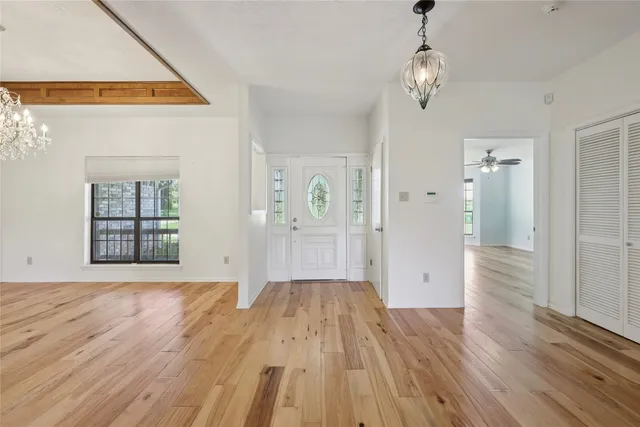 a view of a big room with wooden floor and windows