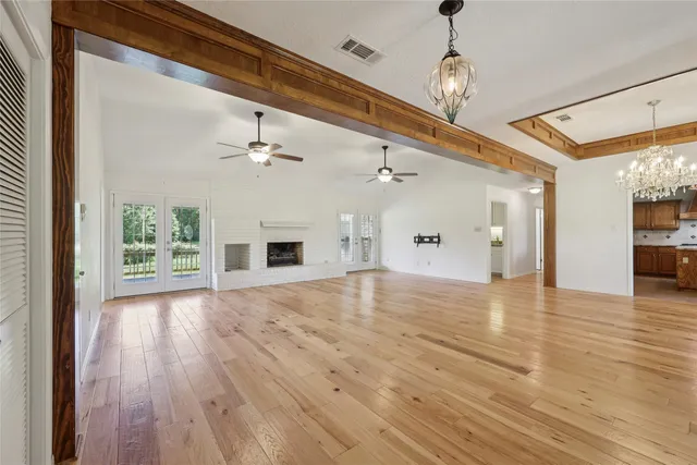 a view of a livingroom with wooden floor and a window