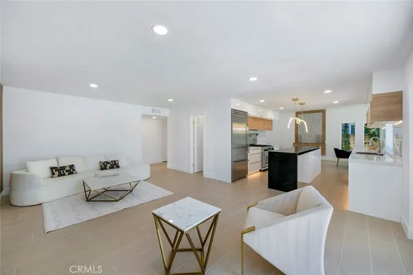 a living room with furniture kitchen view and a table