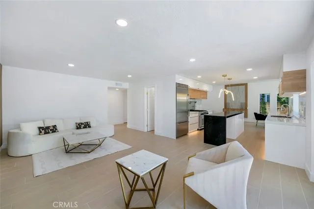 a living room with furniture kitchen view and a table