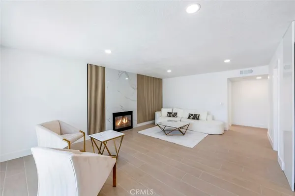 a living room with furniture a fireplace and a table