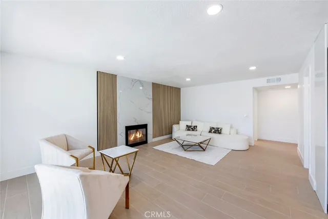 a living room with furniture a fireplace and a table