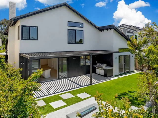 a view of house with backyard and furniture