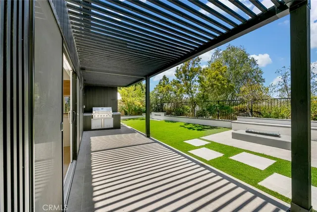 a view of a patio with wooden floor next to a yard