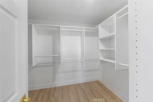 a view of walk in closet with empty racks