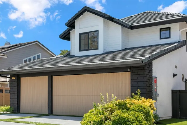a view of a house with potted plants