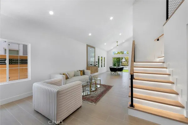 a living room with furniture and a entryway