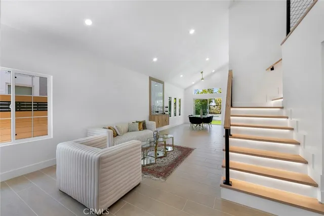 a living room with furniture and a entryway