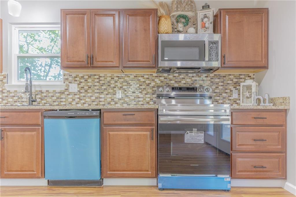 55 Reece Street Menlo, GA 30731 - Photo 12 of 46 a kitchen with stainless steel appliances granite countertop a sink stove and cabinets