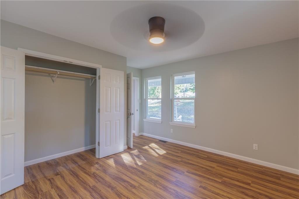 55 Reece Street Menlo, GA 30731 - Photo 17 of 46 an empty room with wooden floor and windows