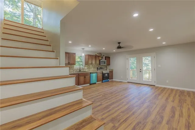 a view of entryway and hall with wooden floor