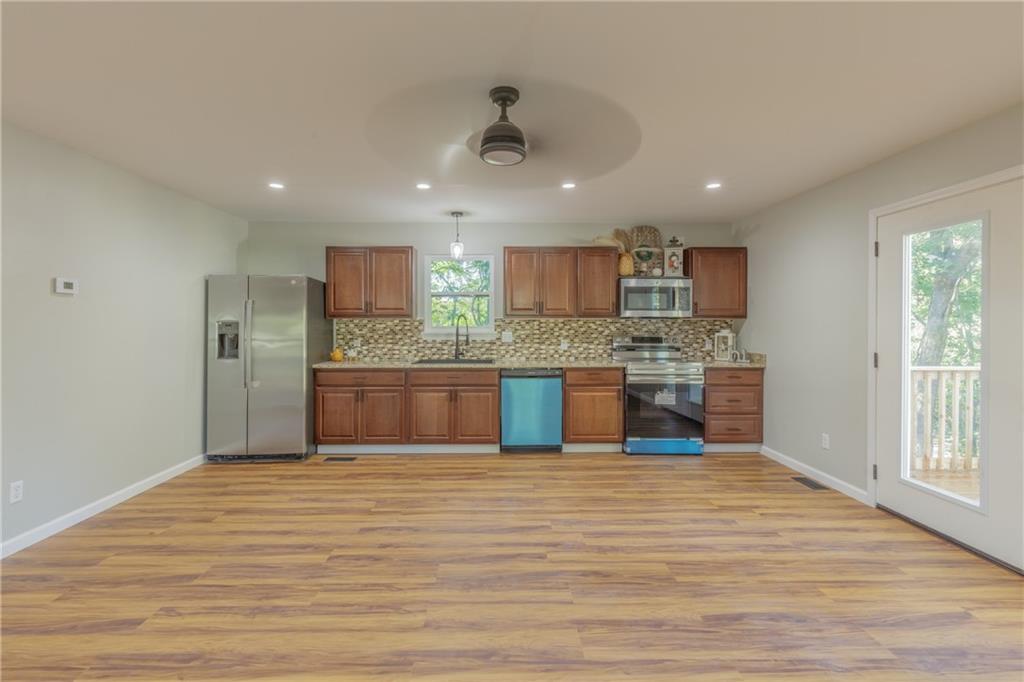 55 Reece Street Menlo, GA 30731 - Photo 6 of 46 a large kitchen with kitchen island a sink stainless steel appliances and cabinets