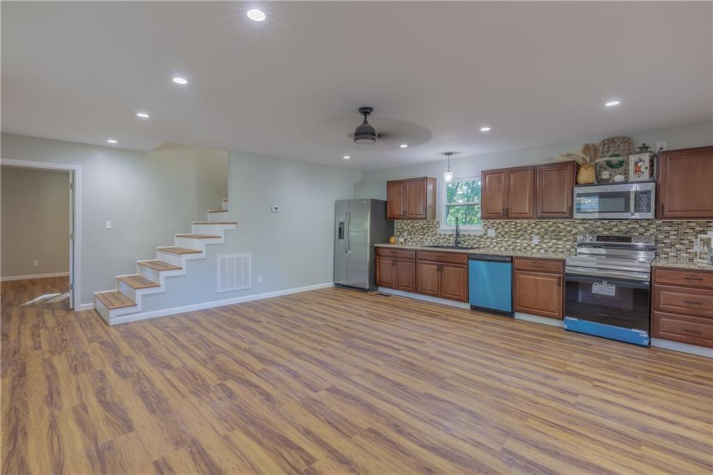 55 Reece Street Menlo, GA 30731 - Photo 7 of 46 a large kitchen with stainless steel appliances granite countertop a large counter top a sink and a stove