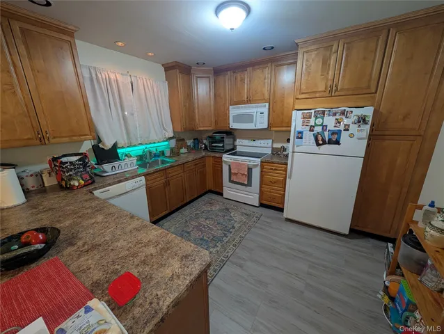 a kitchen with stainless steel appliances granite countertop a refrigerator sink and cabinets