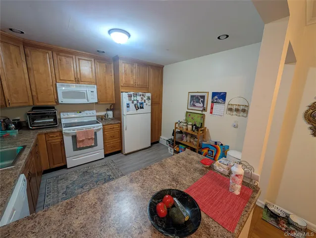 a view of a kitchen with fridge and workspace