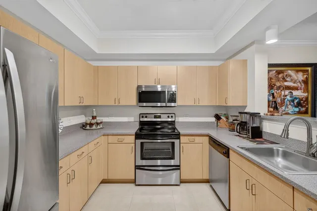 a kitchen with stainless steel appliances a refrigerator stove and microwave
