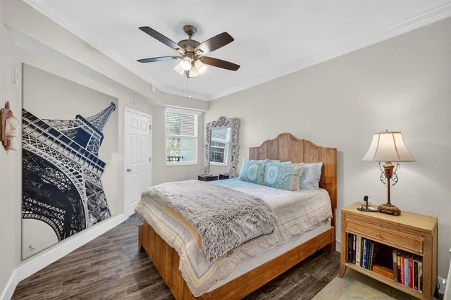 a bedroom with a large bed and a chandelier