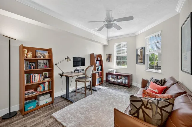 a living room with furniture a flat screen tv and a window