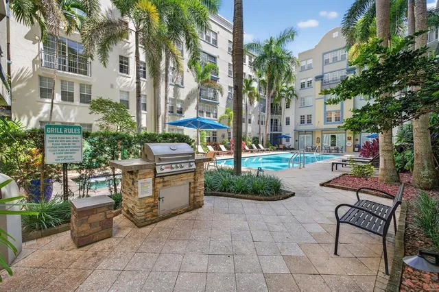 a view of swimming pool with outdoor seating and a potted plant