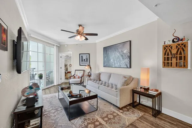 a living room with furniture a flat screen tv and a window