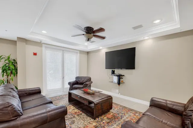 a living room with furniture pool table and a chandelier