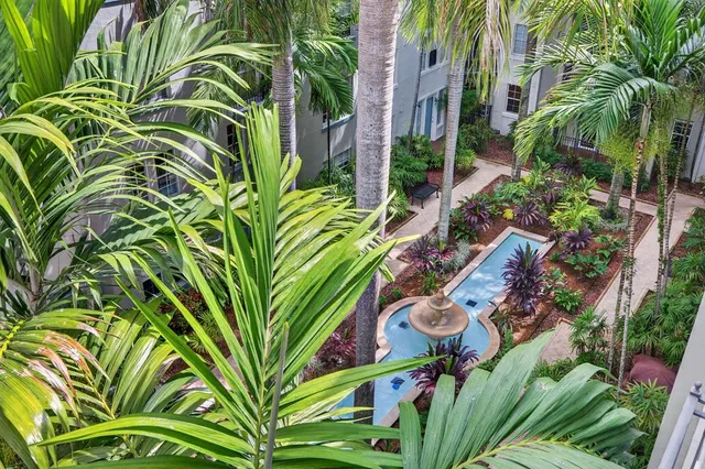 a balcony with furniture and a potted plant