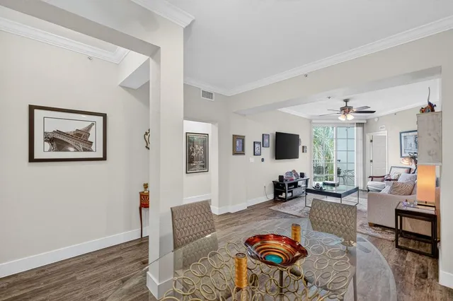 a dining room with furniture and kitchen view