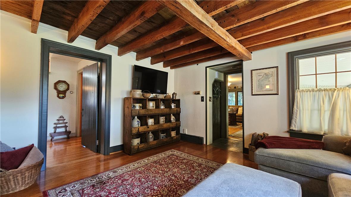 585 Buttermilk Road Hellertown, PA 18055 - Photo 17 of 82 Rich hardwood flooring and exposed wood beams define this welcoming interior space.