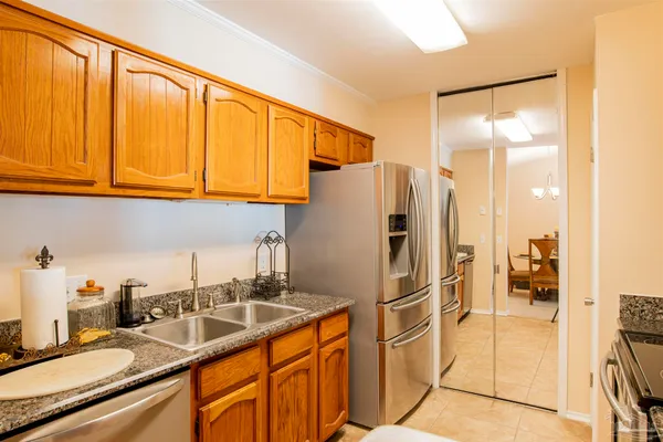 a kitchen with stainless steel appliances granite countertop a refrigerator and a sink