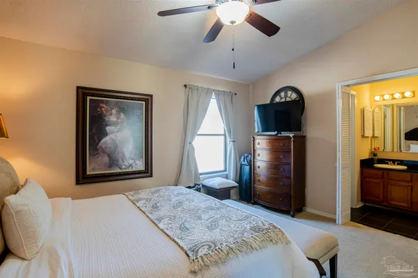 a bedroom with a bed and a television