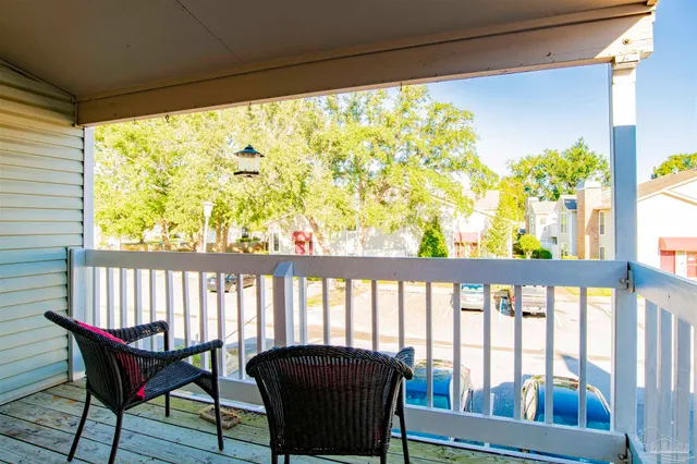 a view of a porch with furniture and a yard
