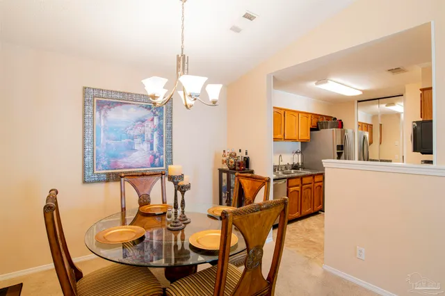 a view of a dining room with furniture and a chandelier