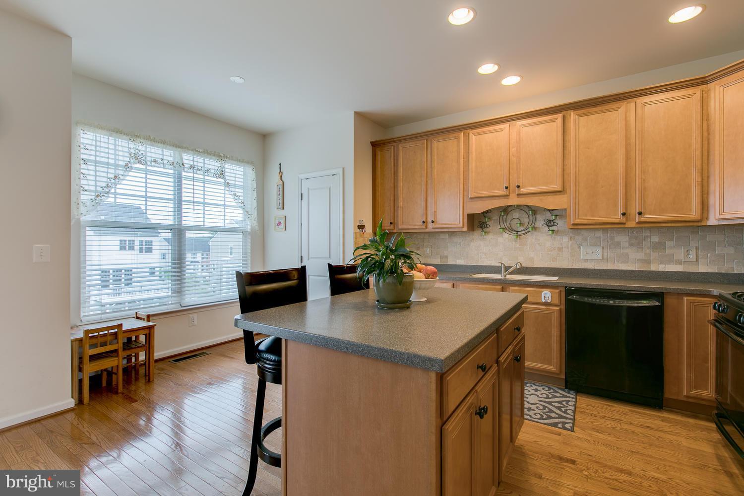42 Short Branch Road Stafford, VA 22556 - Photo 12 of 26 a kitchen with kitchen island granite countertop a sink cabinets and wooden floor