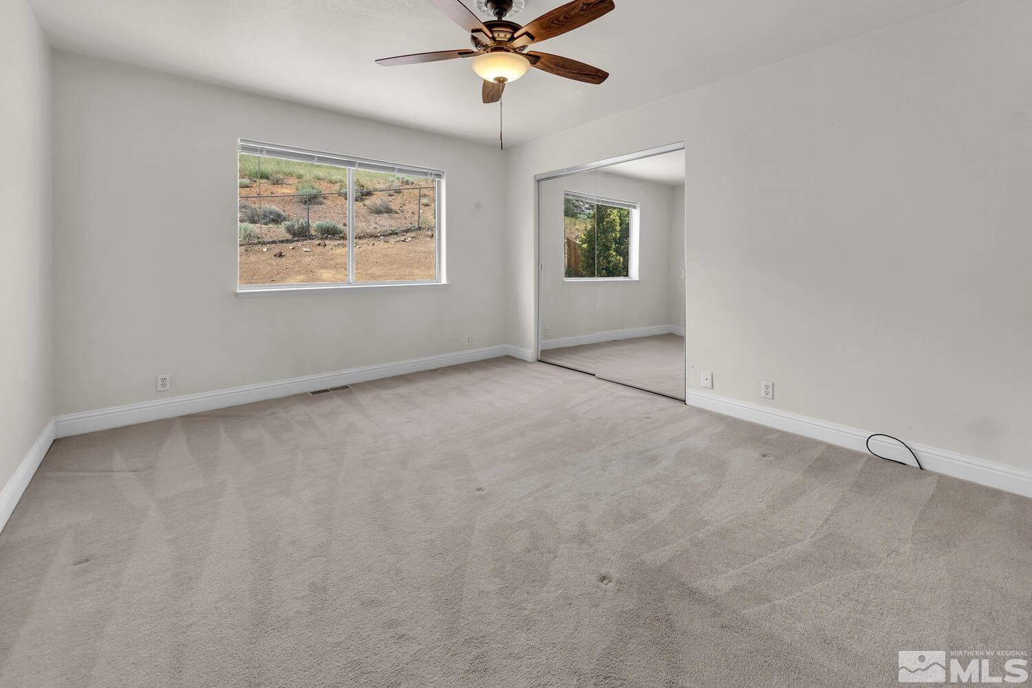 1031 University Ridge Drive Reno, NV 89512 - Photo 14 of 38 an empty room with windows and fan