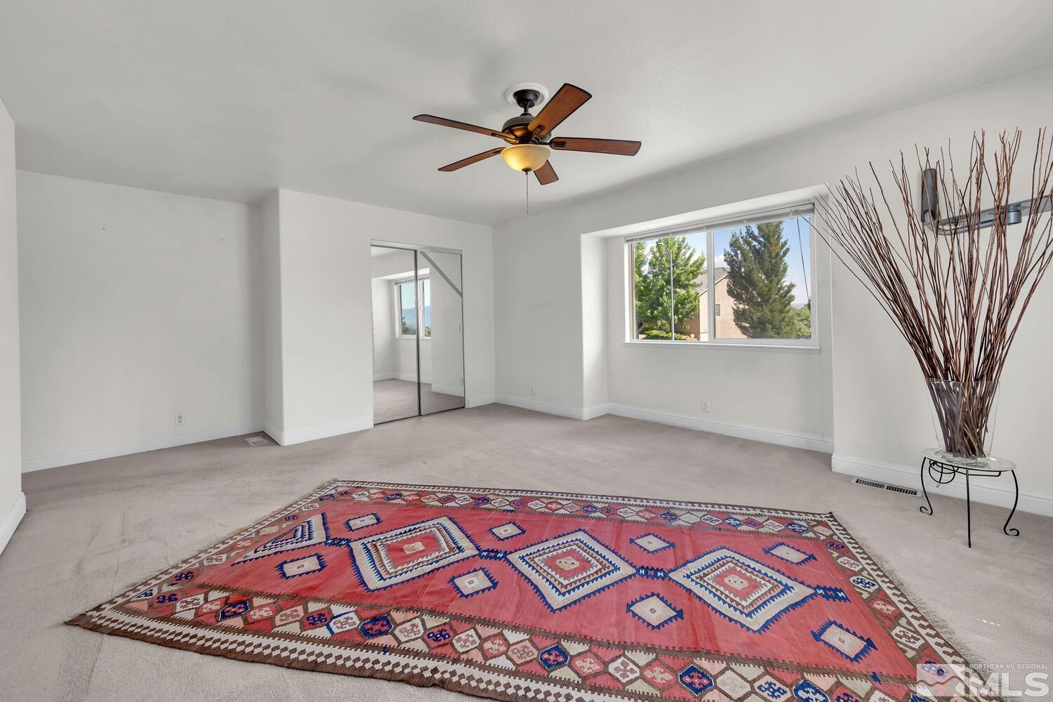 1031 University Ridge Drive Reno, NV 89512 - Photo 16 of 38 a bedroom with a bed and a chandelier