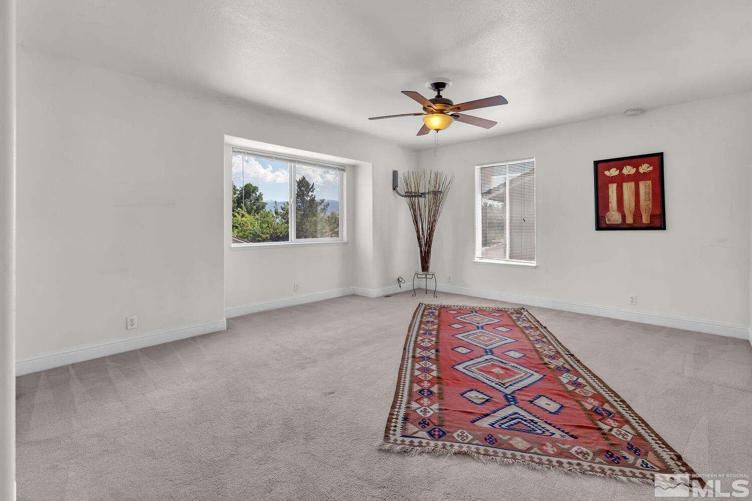 1031 University Ridge Drive Reno, NV 89512 - Photo 17 of 38 a view of an empty room with window and wooden floor